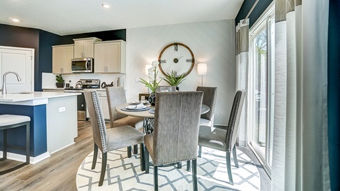 Model home dining area with table and chairs