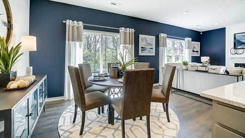 Model home dining area with table and chairs