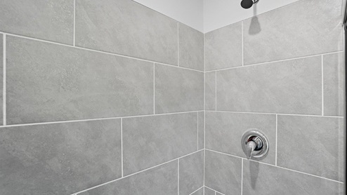ensuite walk in shower with tile walls