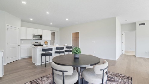 dining space with table and chairs, kitchen