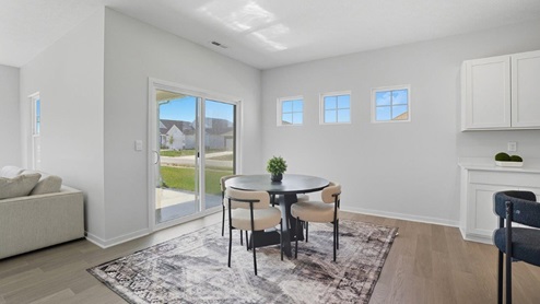 dining space with table, chairs and rear sliding door