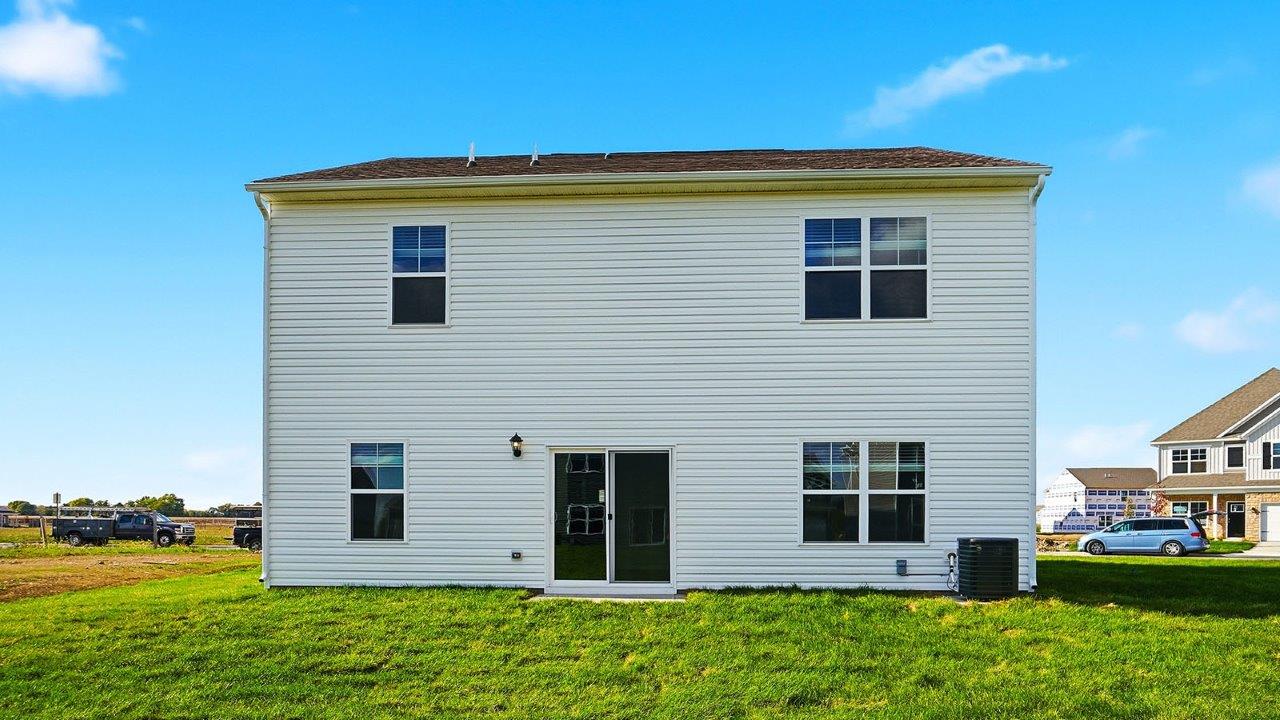 two story home with white siding rear exterior