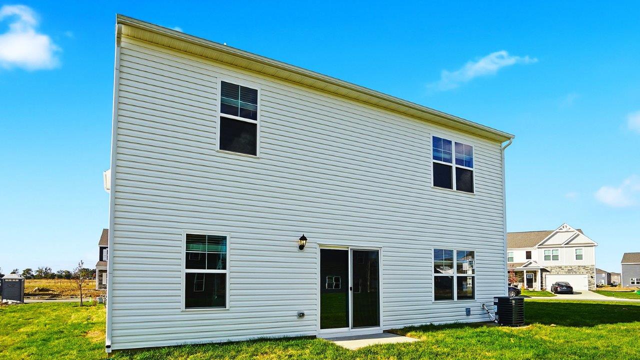 two story home with white siding rear exterior at an angle