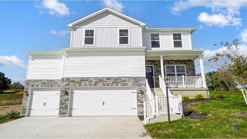 two story home with white siding, steps with railing to covered front porch, three car garage, partial stone front