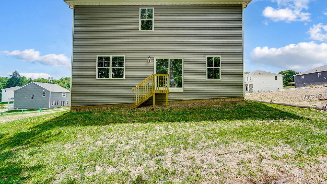 two story home with grey siding rear exterior