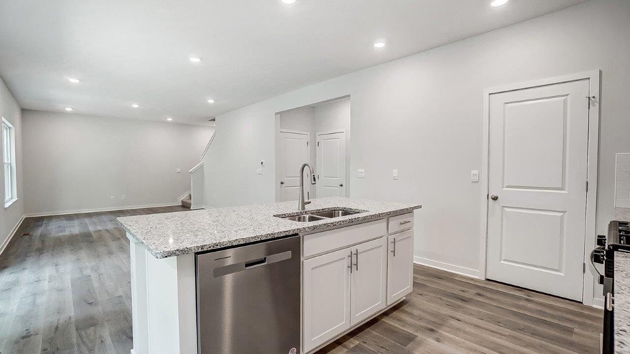 built in kitchen island, walk in pantry and great room