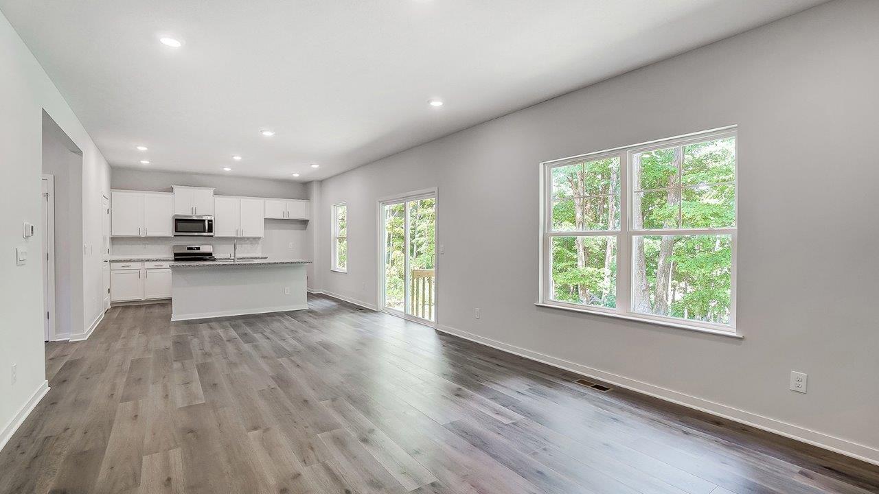 great room with double window, rear sliding door, kitchen