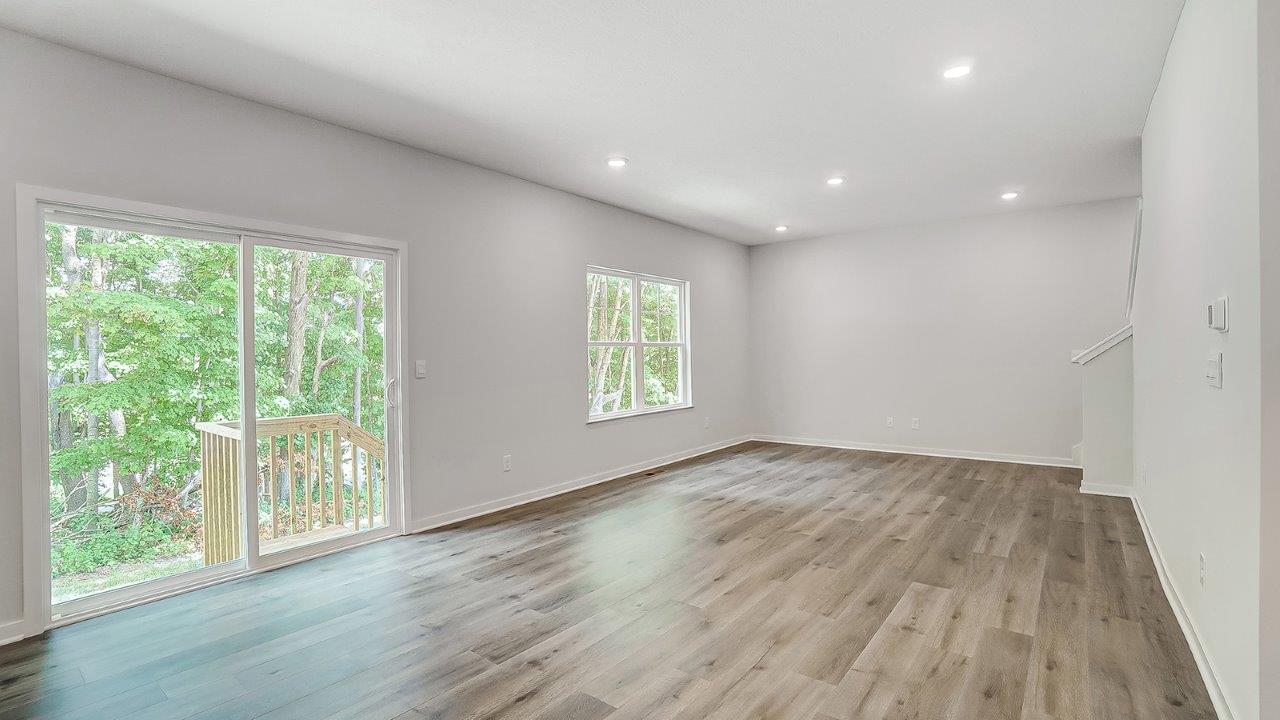 great room with rear sliding door and double window