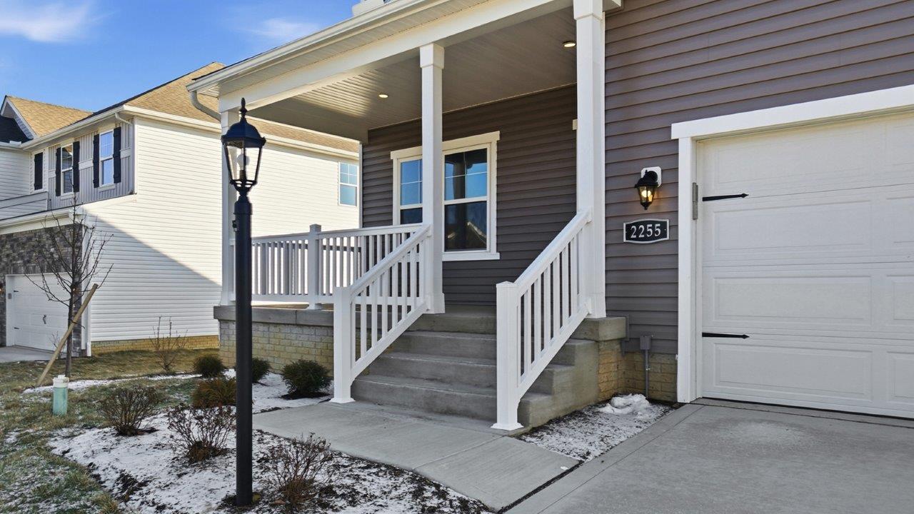 covered front porch with white railing