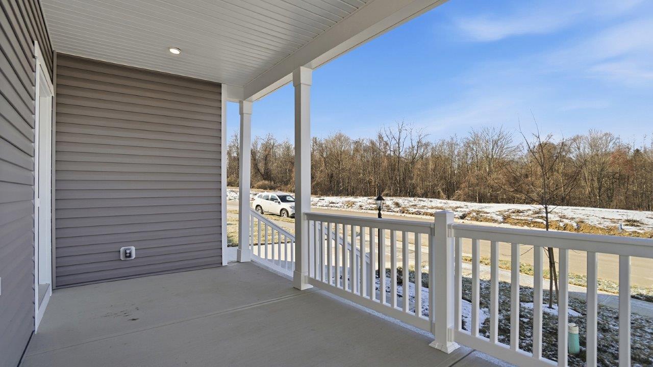 covered front porch with white railing