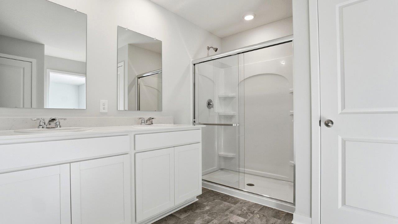 ensuite bath with double vanity, walk in shower, water closet
