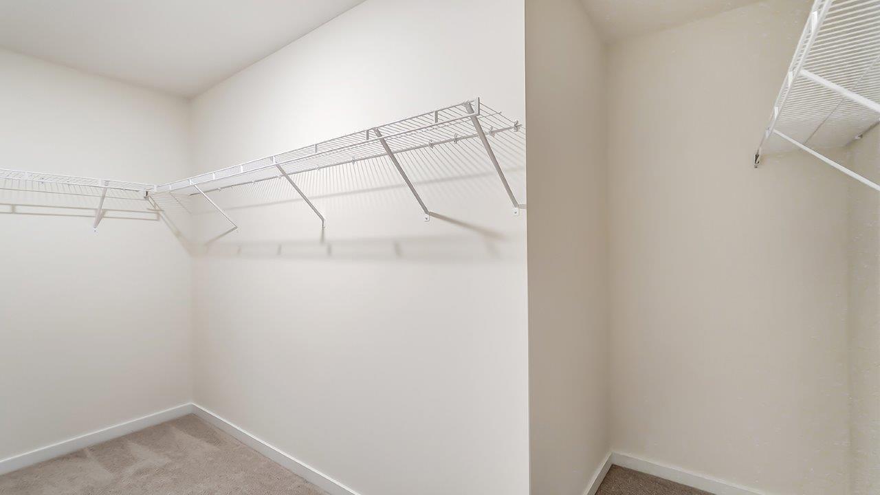 primary walk in closet with wire shelving