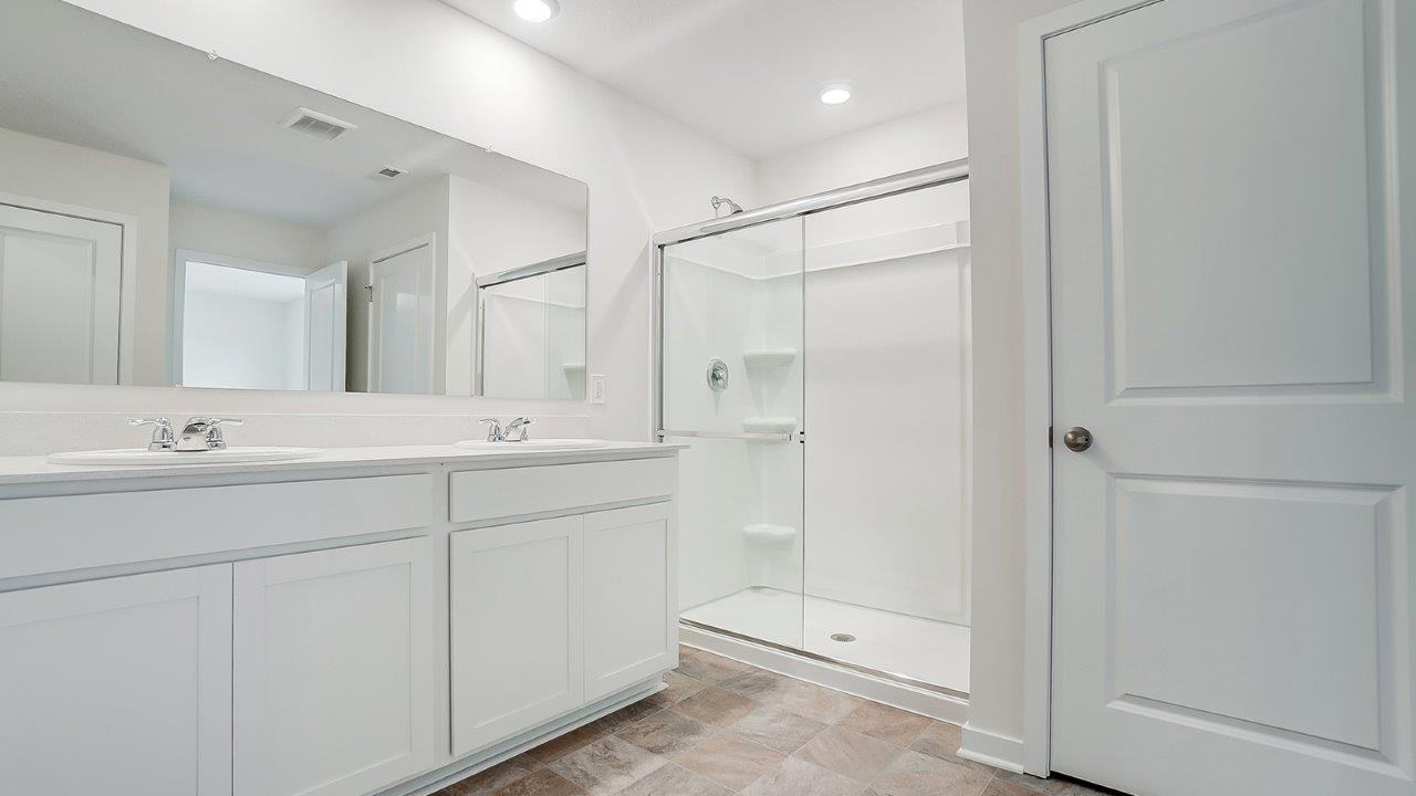 primary ensuite bath with double vanity, walk in shower, water room