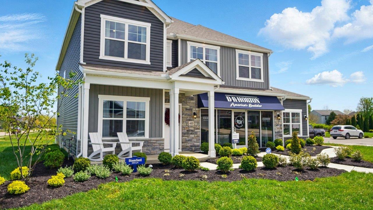 Front exterior of a Stamford model home featuring blue and gray siding