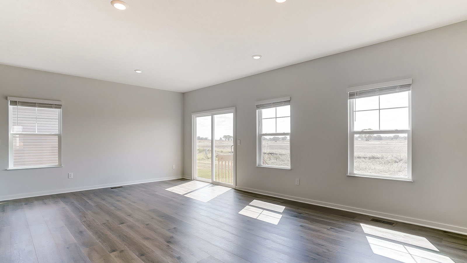 great room with single windows and rear sliding doors