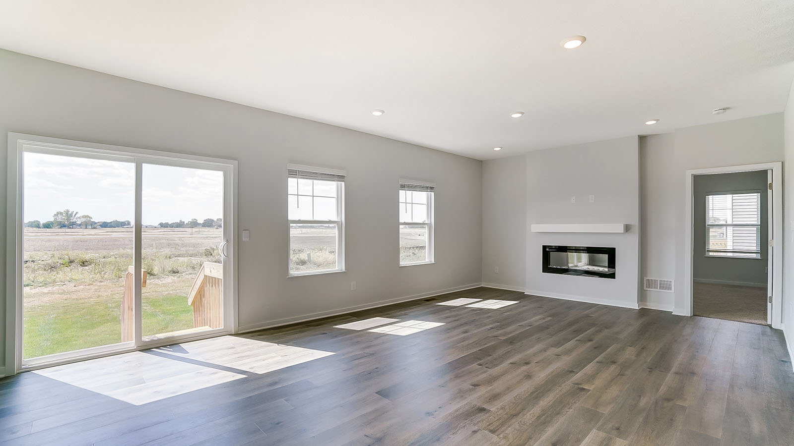 great room with rear sliding doors, single windows