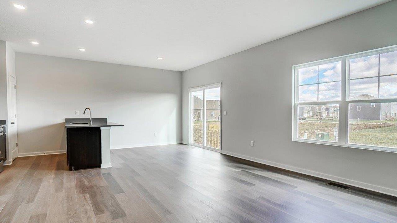 great room with rear sliding door and double window