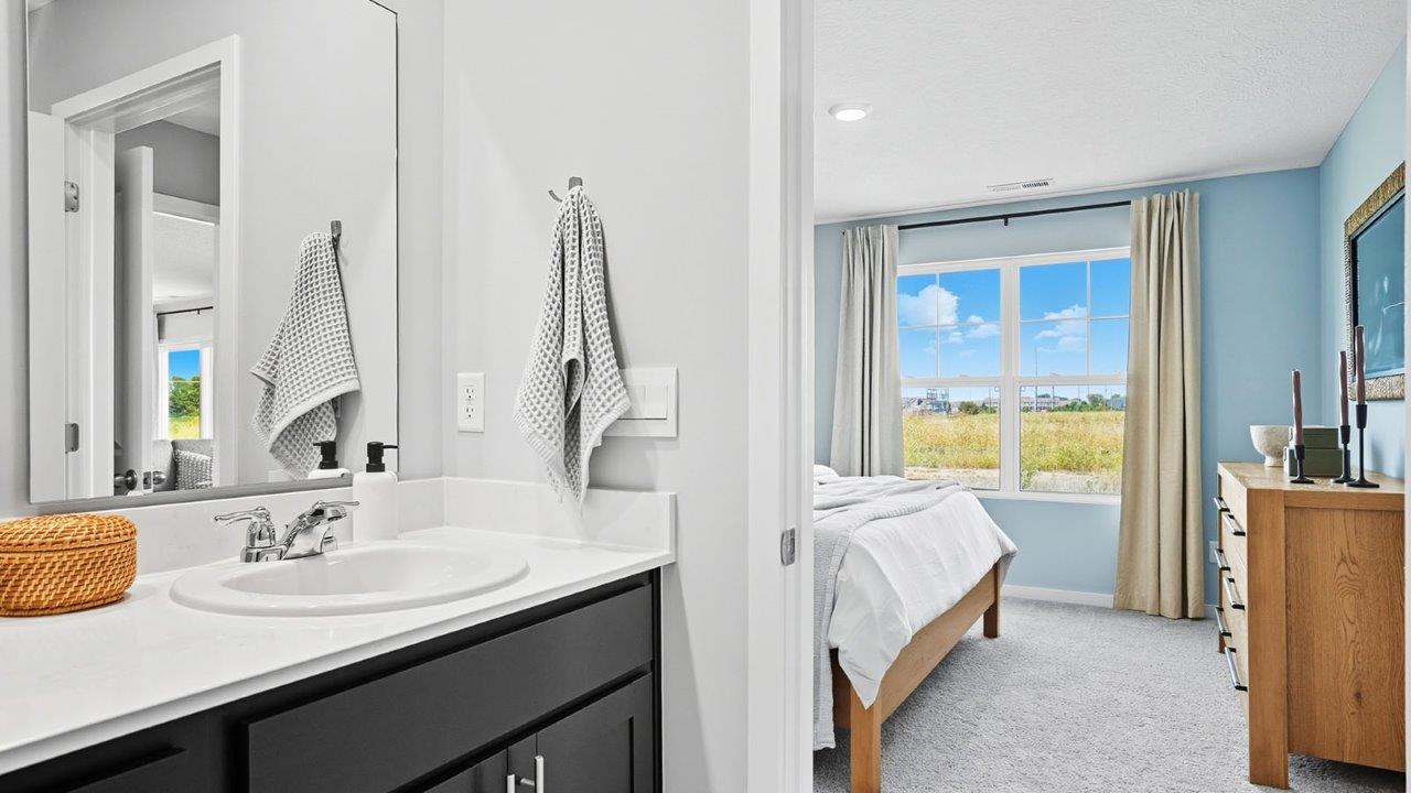 ensuite bathroom and primary bedroom