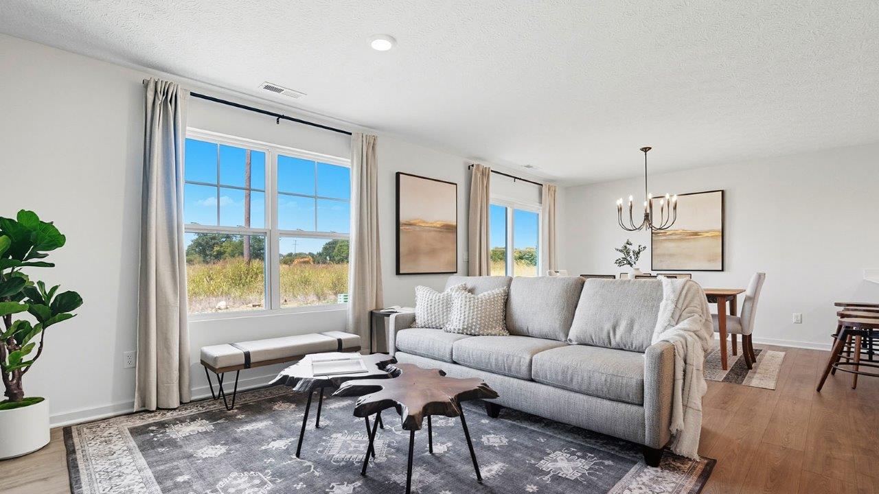 furnished great room with double window and dining