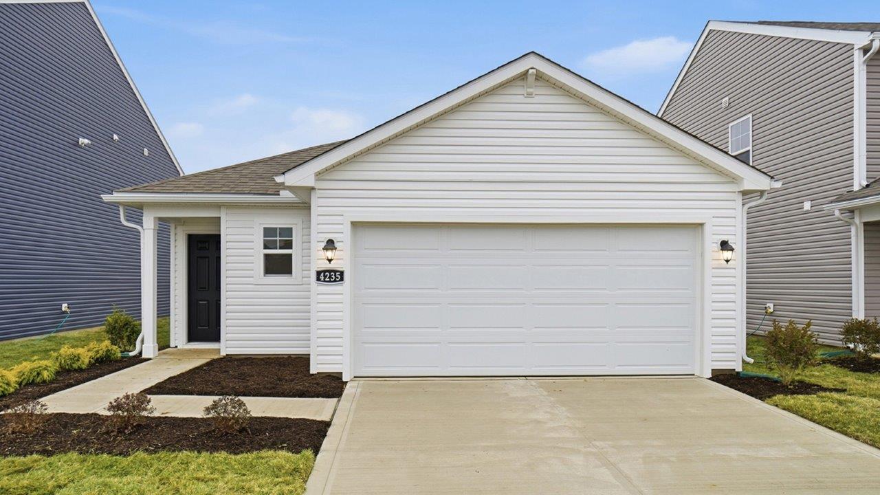 single story home with white siding and black front door, covered entry and two car garage
