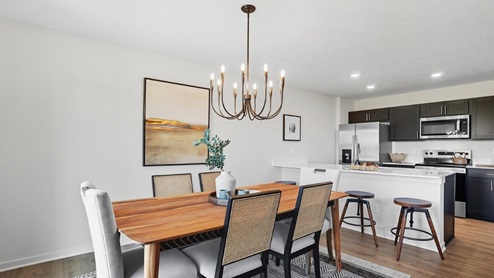 dining table with chairs, decorative lighting, kitchen