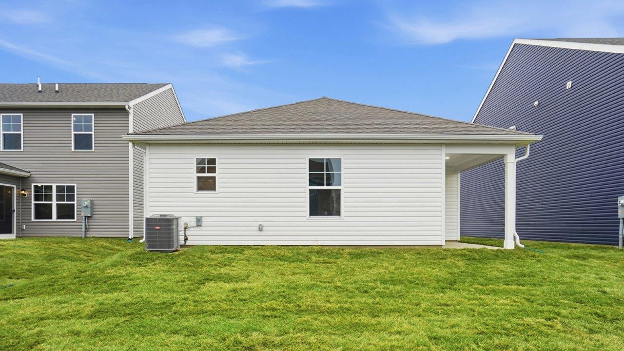 single story home with white siding with covered rear patio, rear exterior