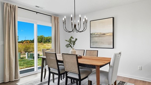 dining table with chairs, decorative lighting, rear sliding door