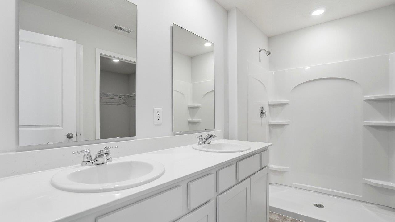 ensuite bath with double vanity and shower tub combo