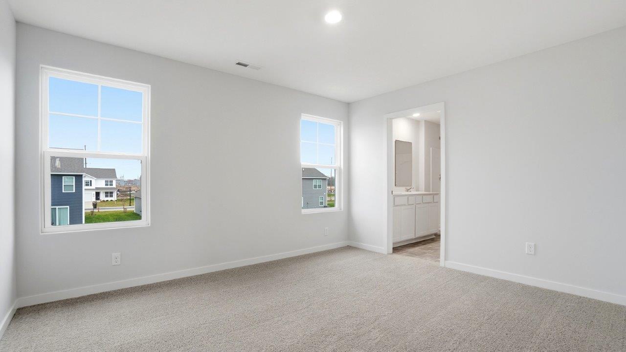 primary bedroom with single windows and ensuite bath