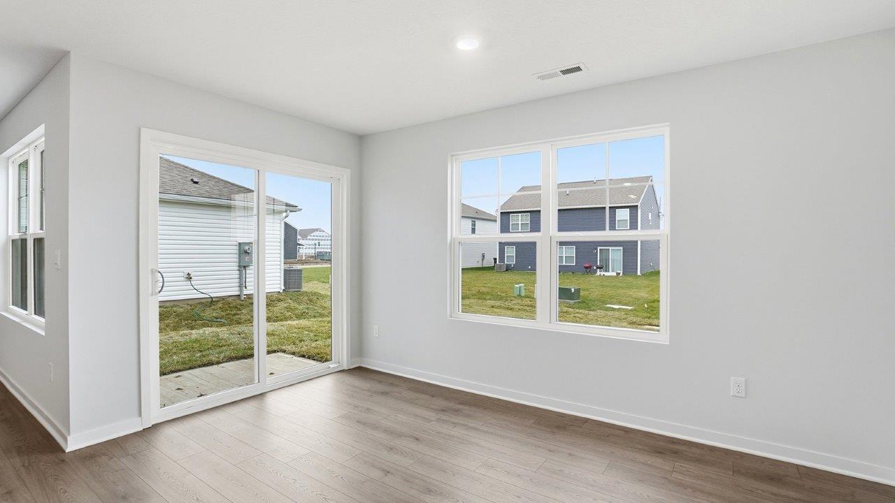 dining space with double window and rear sliding door
