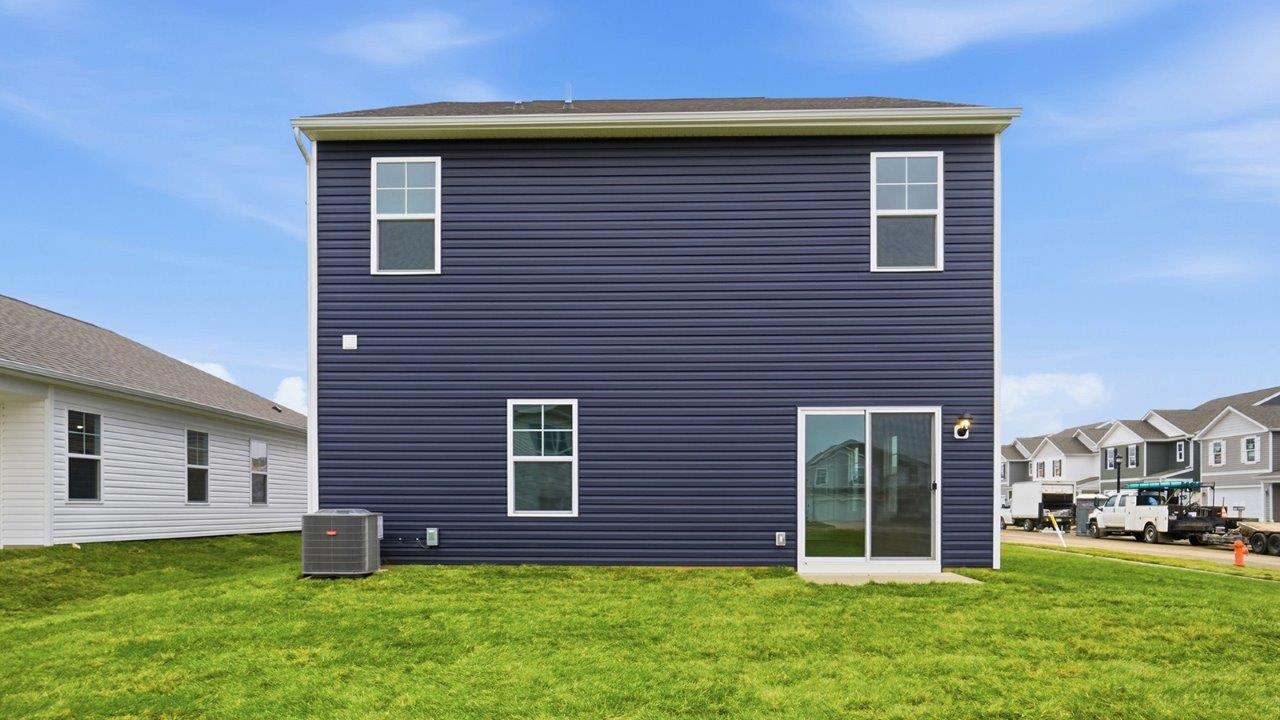 two story home with blue siding rear exterior