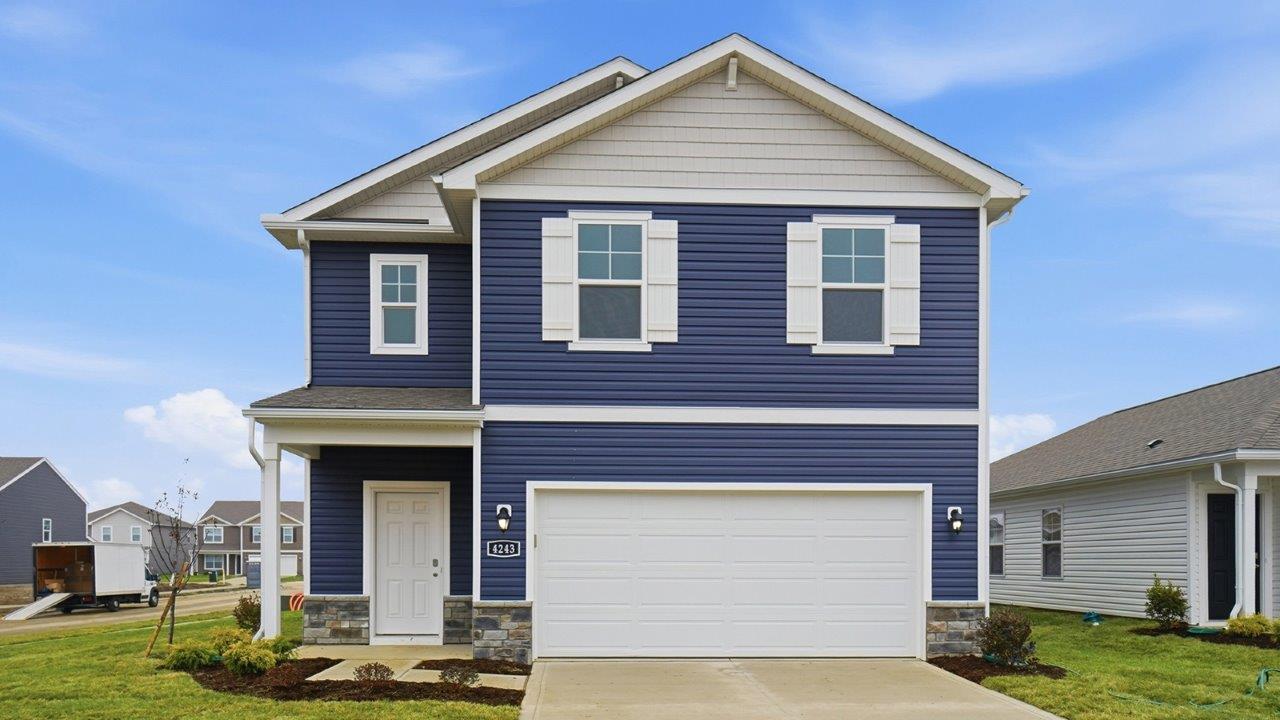 two story home with blue siding, covered entry and two car garage