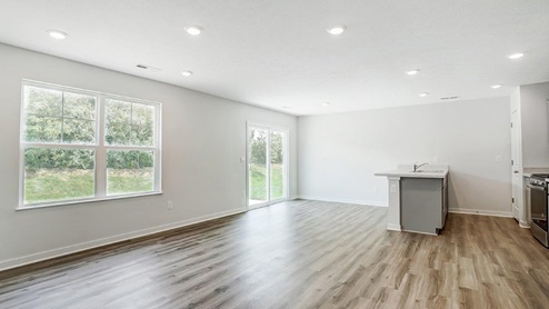 great room with double window, dining space and kitchen