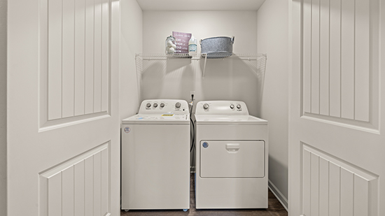 laundry closet with washer, dryer and wire shelving