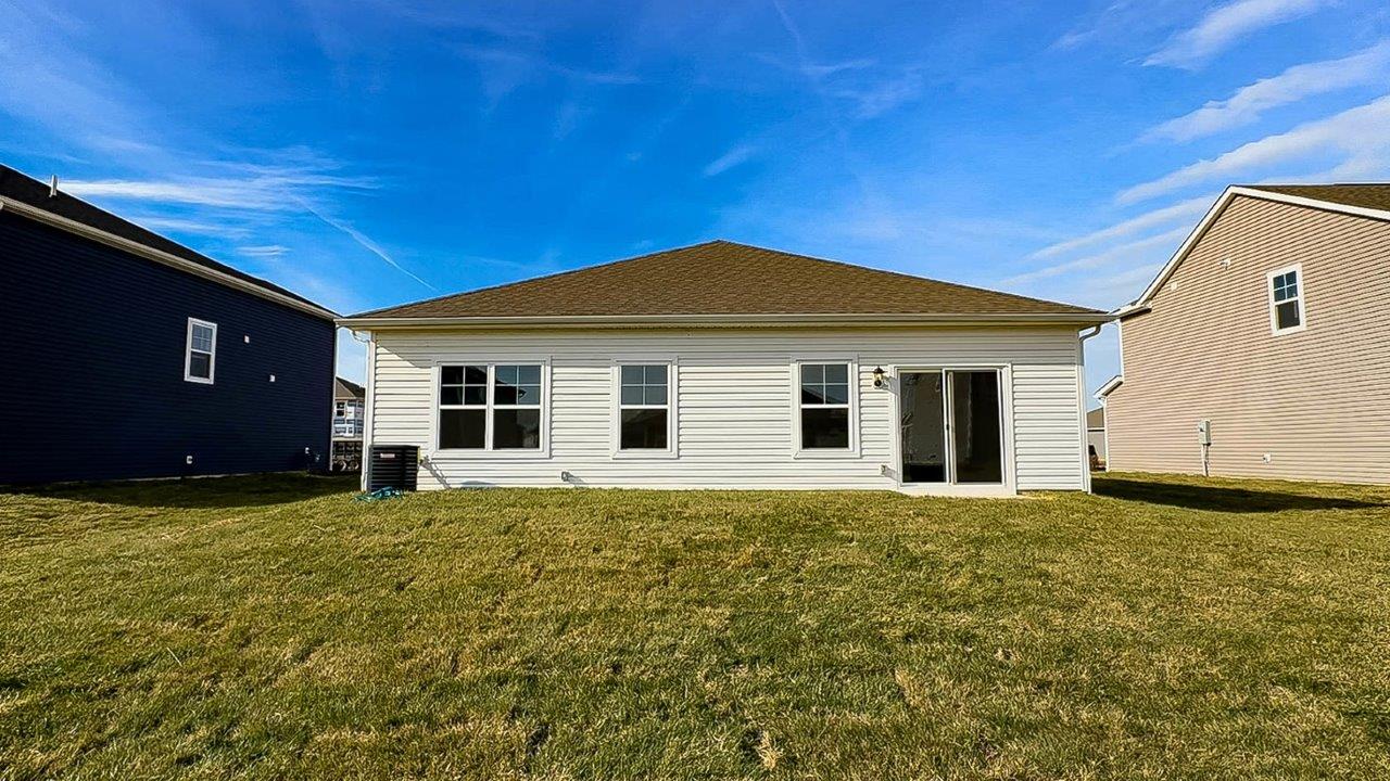 single story home with white siding rear exterior