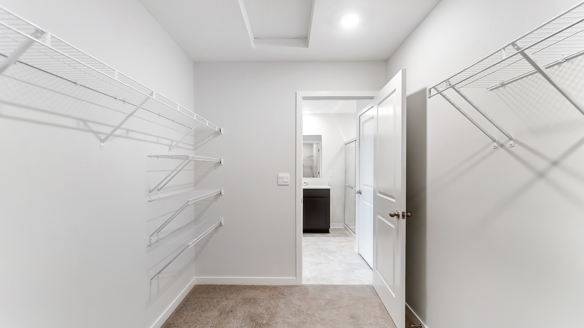 primary walk in closet with wire shelving