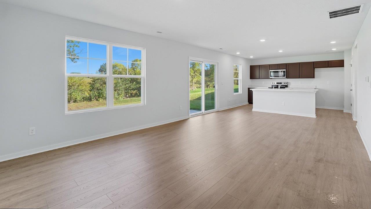 great room with double window, rear sliding door, kitchen