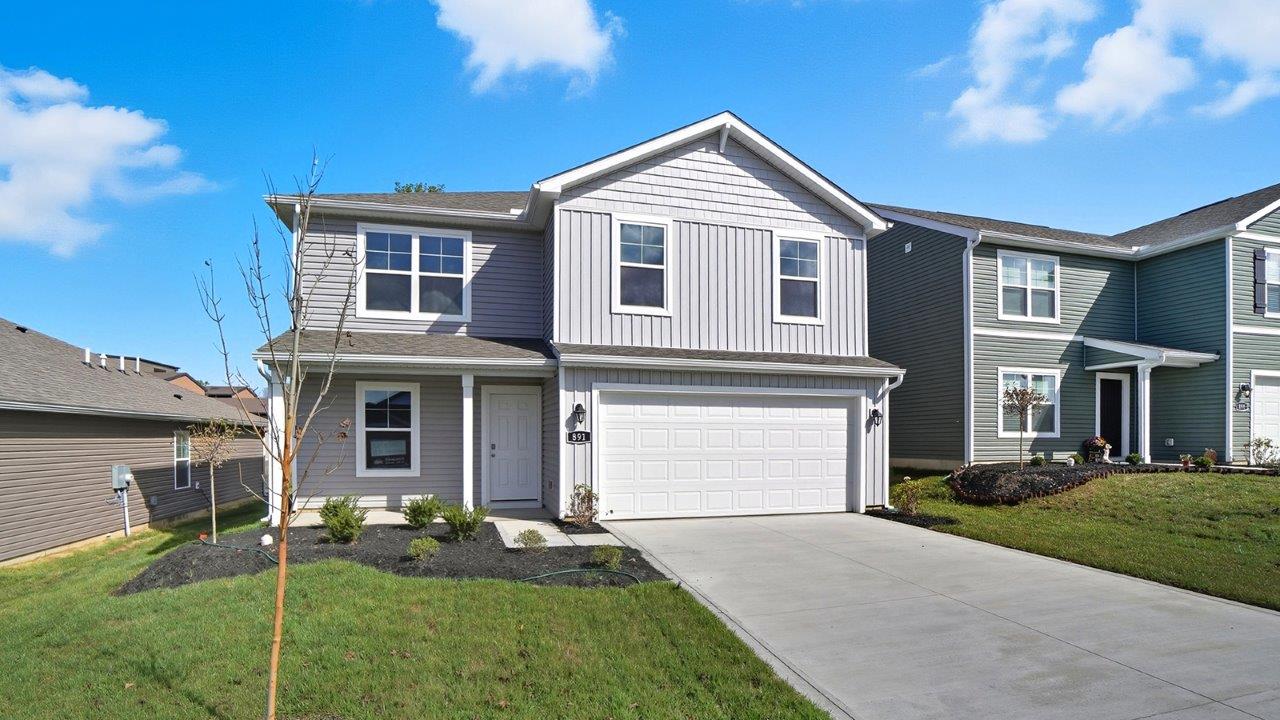 two story home with grey siding, covered front porch and two car garage