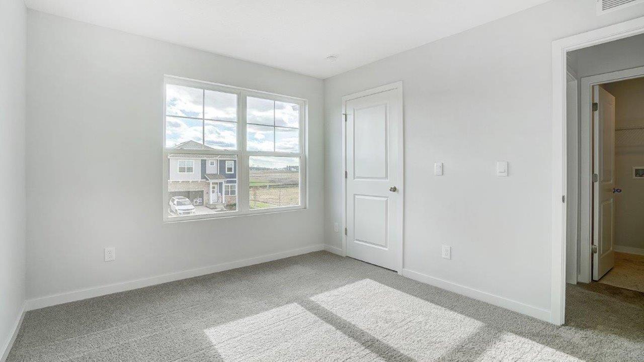 second bedroom with double window, closet and entry