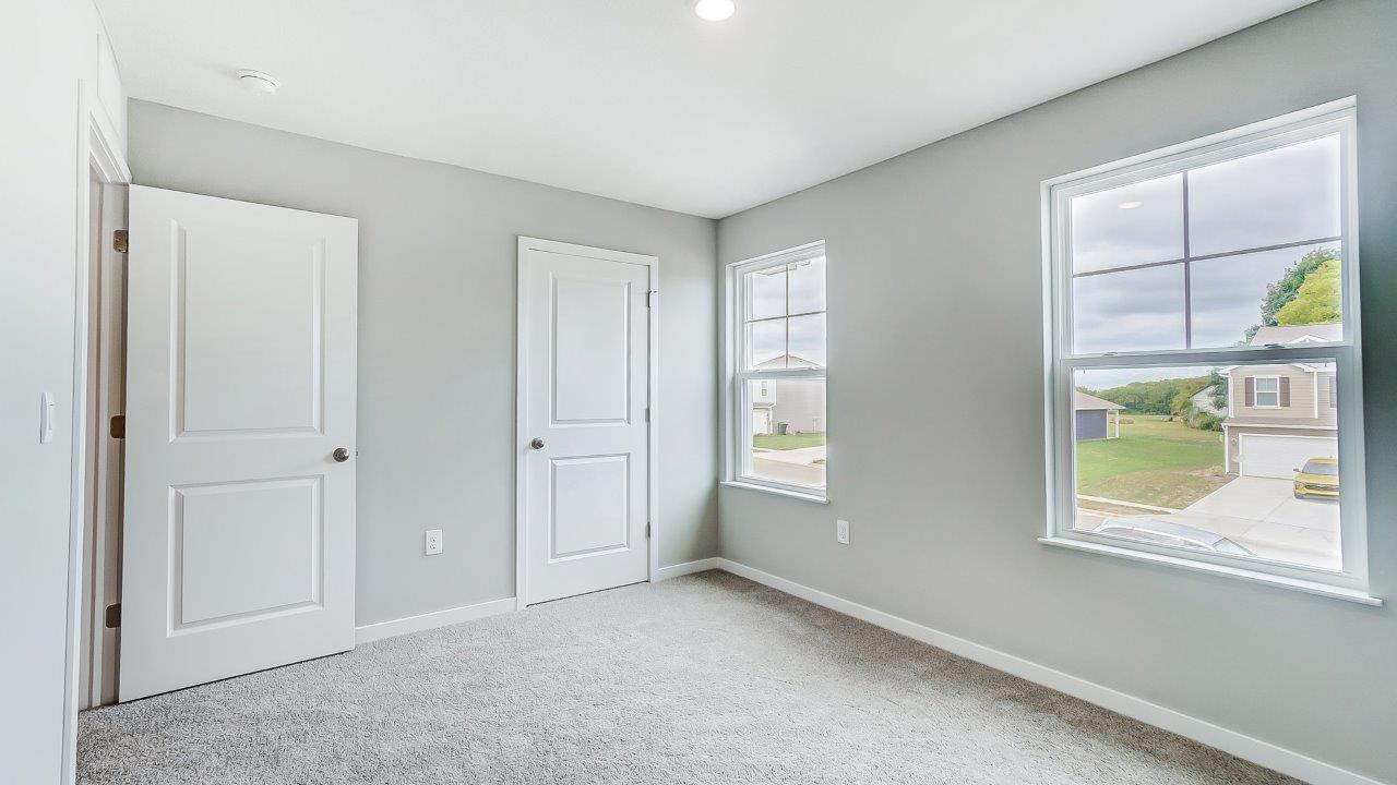 second bedroom with closet and single windows