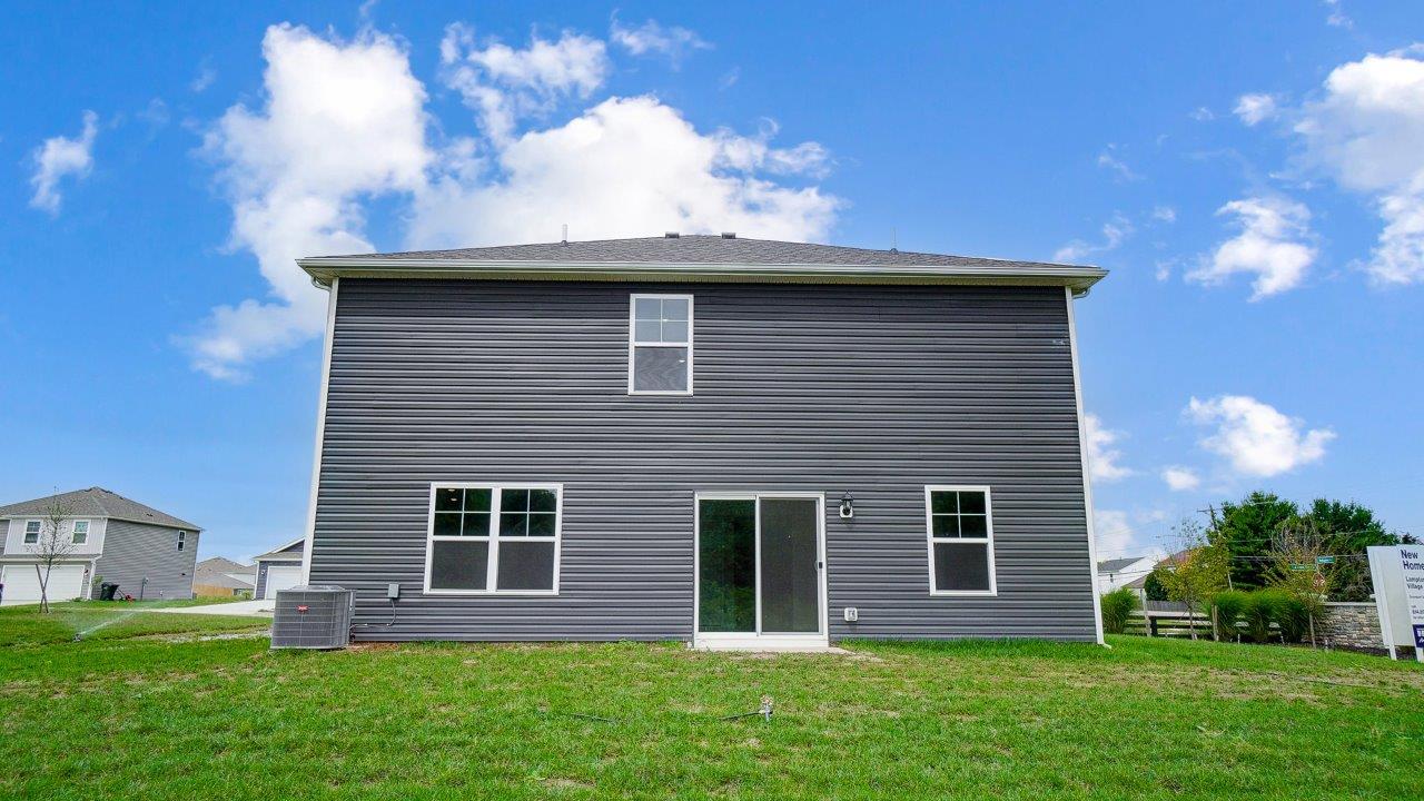 two story home with grey siding rear exterior
