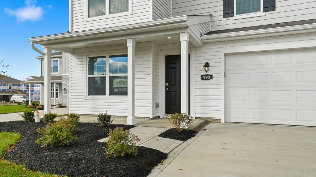 covered front porch with double window and black front door