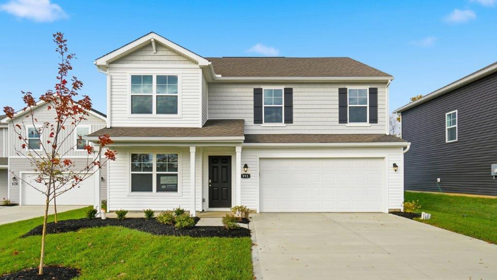 two story home with white siding, covered front porch and two car garage