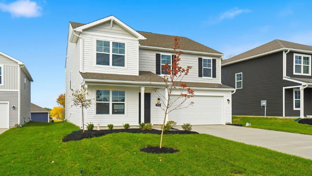two story home with white siding, covered front porch and two car garage