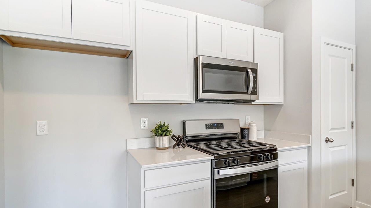 white cabinets, stainless steel appliances