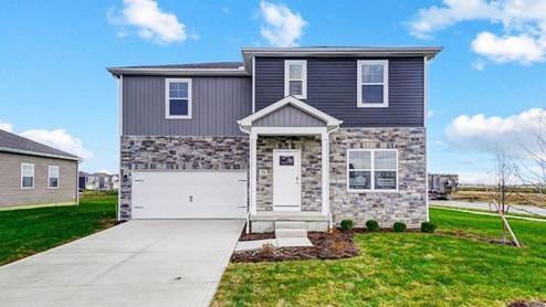 two story home with grey siding, partial stone front, covered entry, two car garage