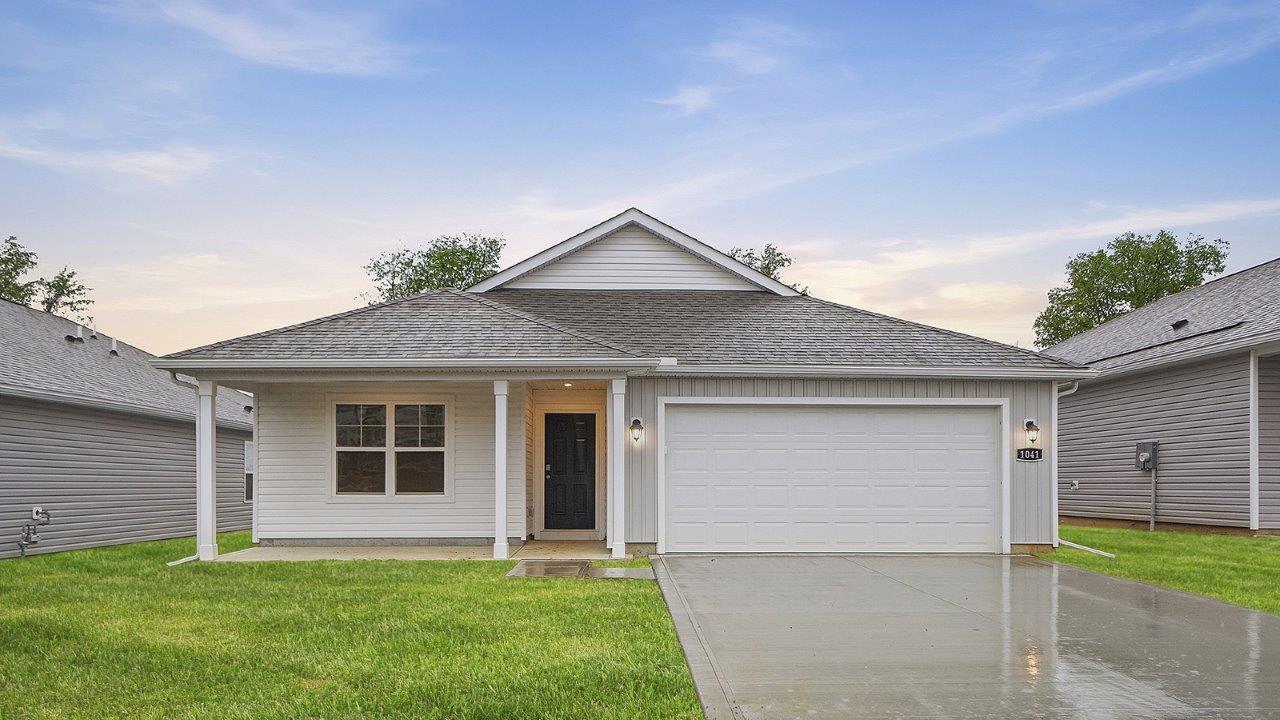single story home with white siding, covered front porch and two car garage