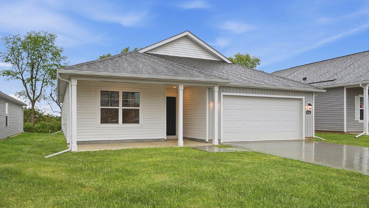 single story home with white siding, covered front porch and two car garage