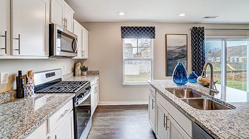 kitchen cabinets, hard surface counters, stainless steel appliances with single window