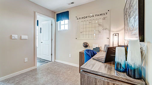 second floor landing with desk and laundry room entry